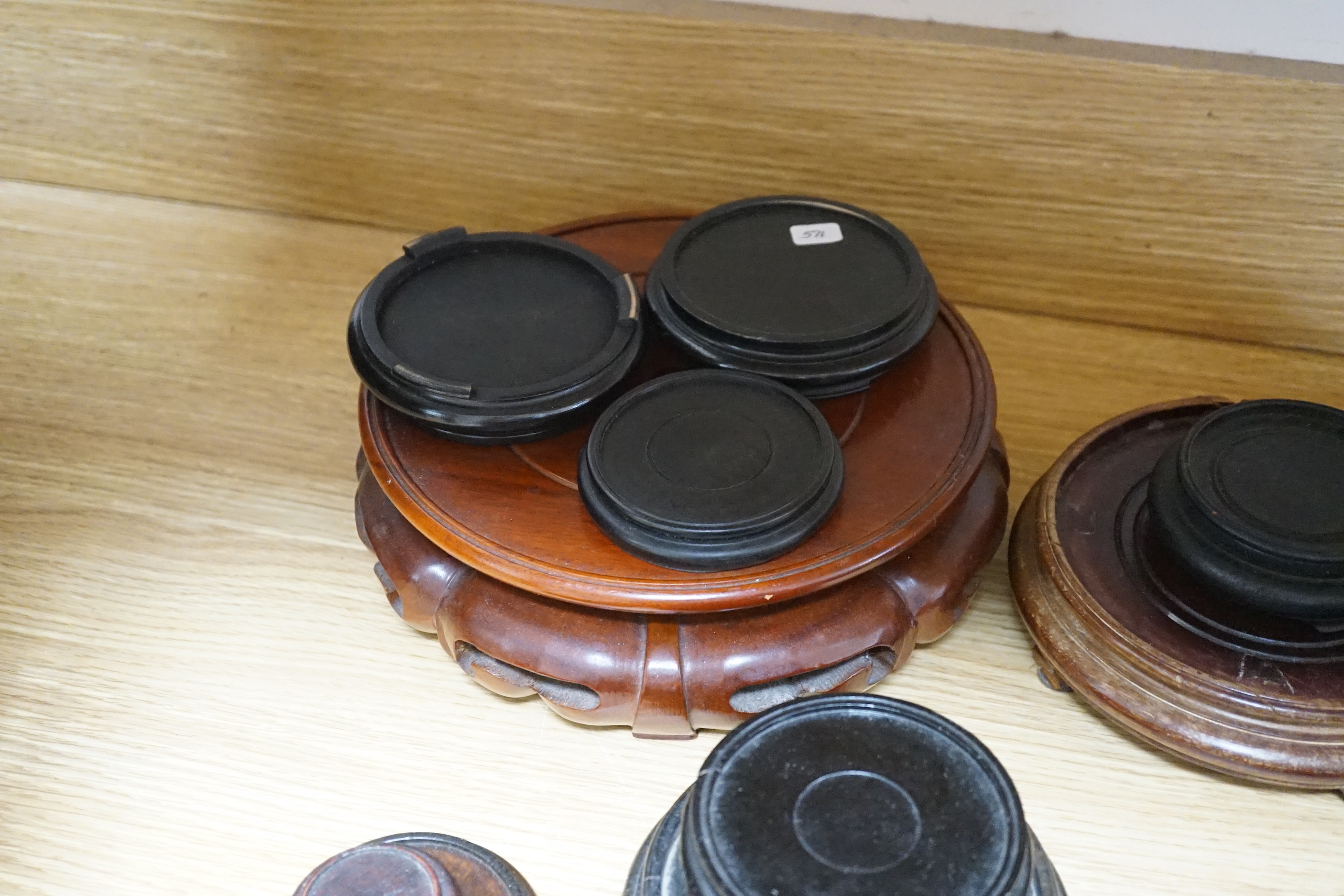A group of Chinese hardwood stands, some with pierced and carved decoration, largest 22cm in diameter